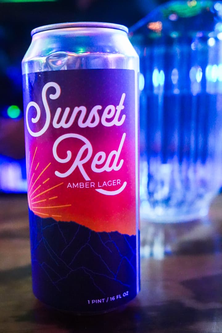 a can of beer sitting on a table