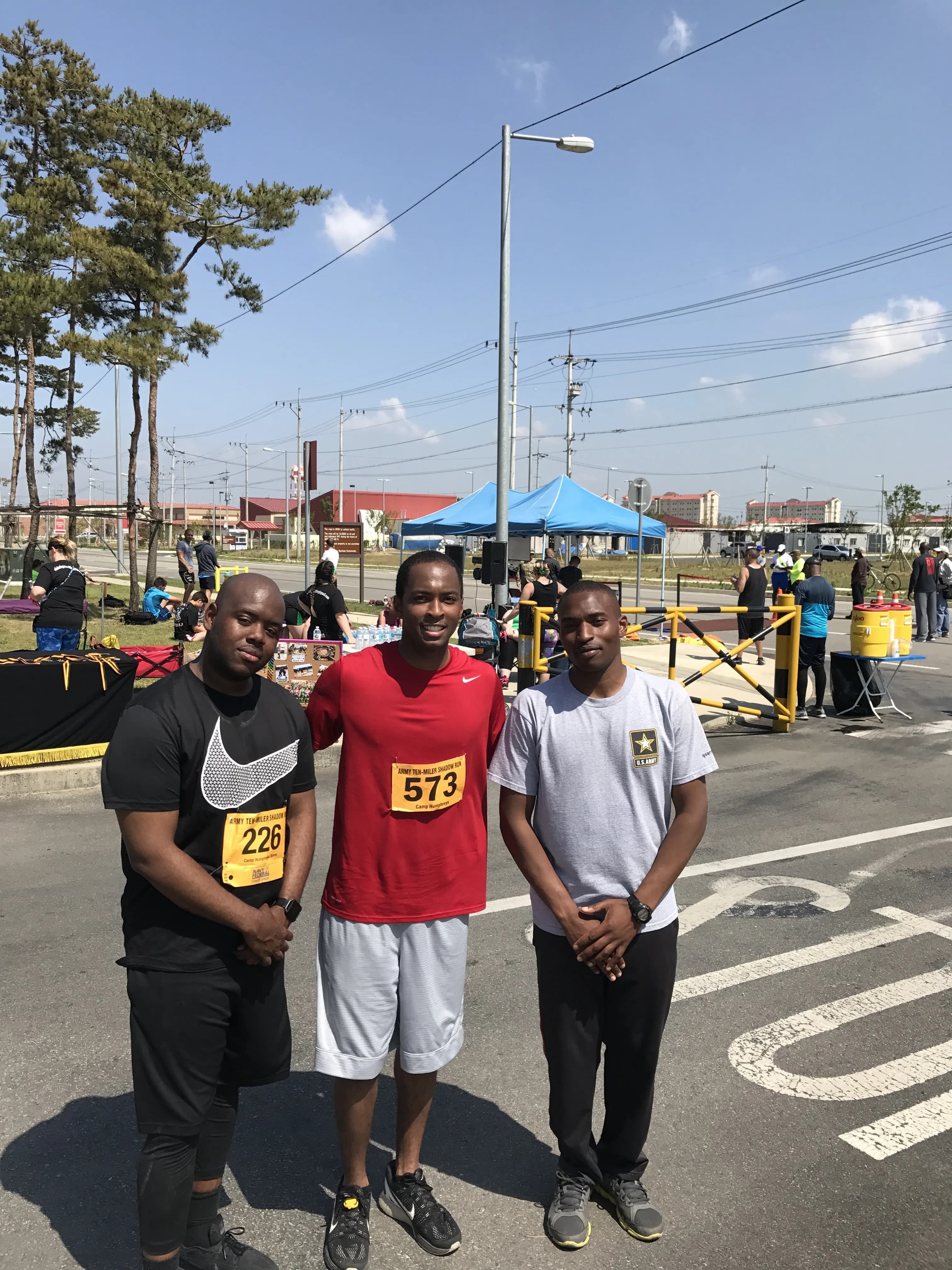 three men standing in a parking lot