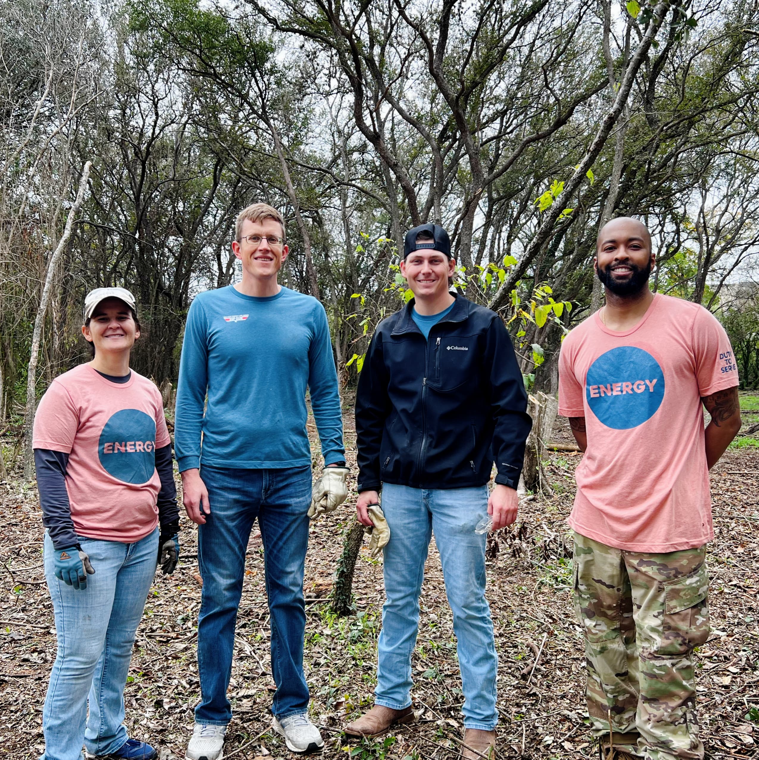 a group of people standing in a forest