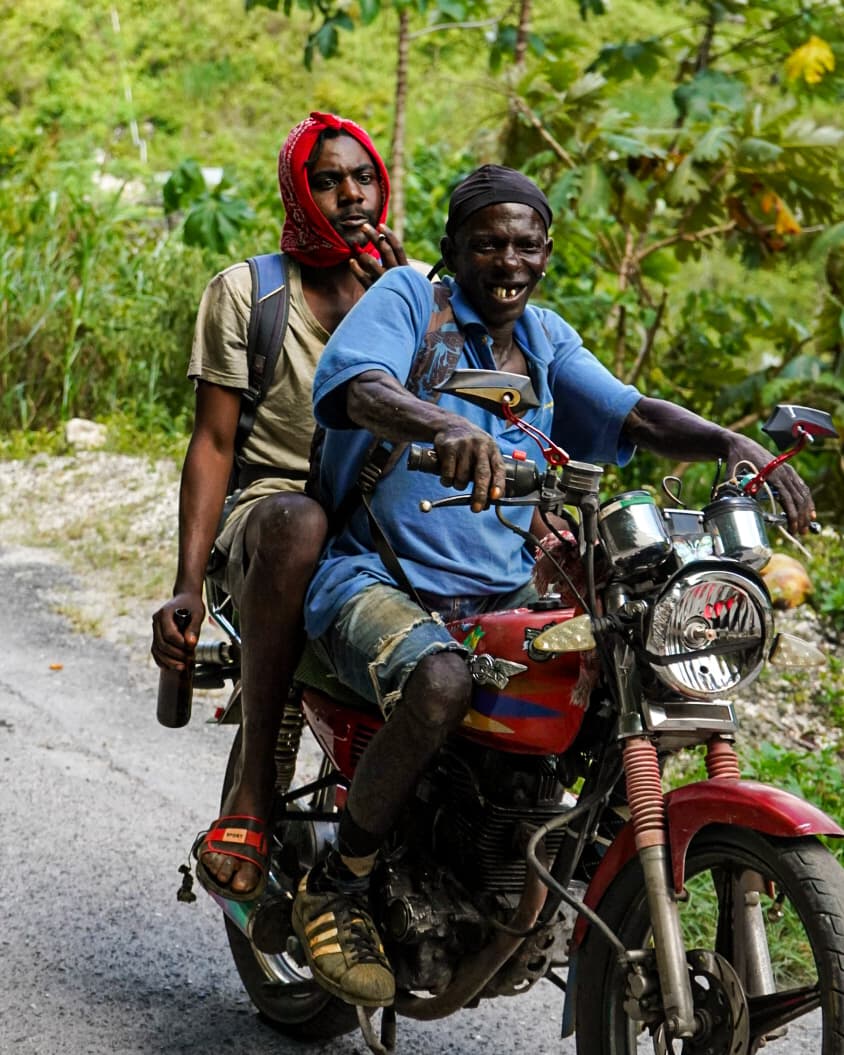 two men riding on a motorcycle