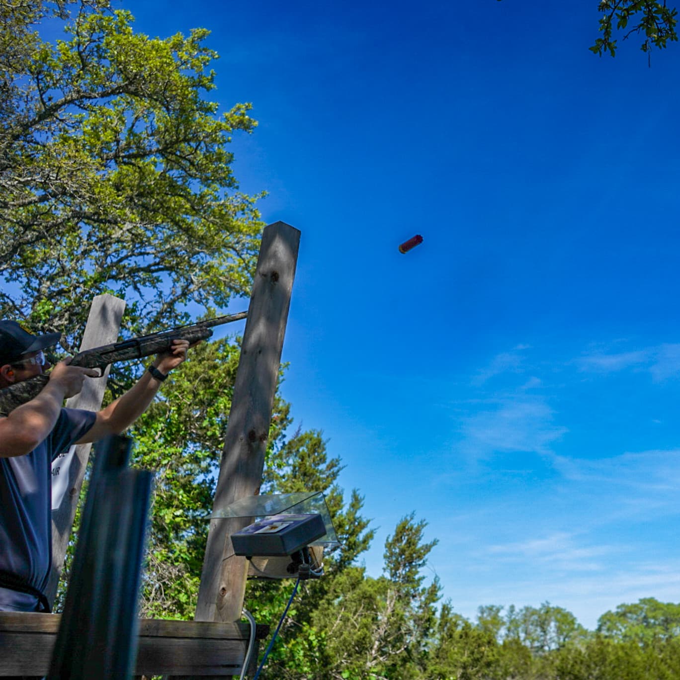a man is shooting a gun at a target