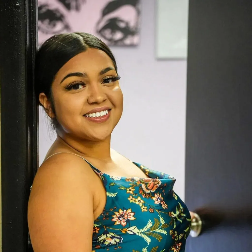 a woman in a blue dress smiling