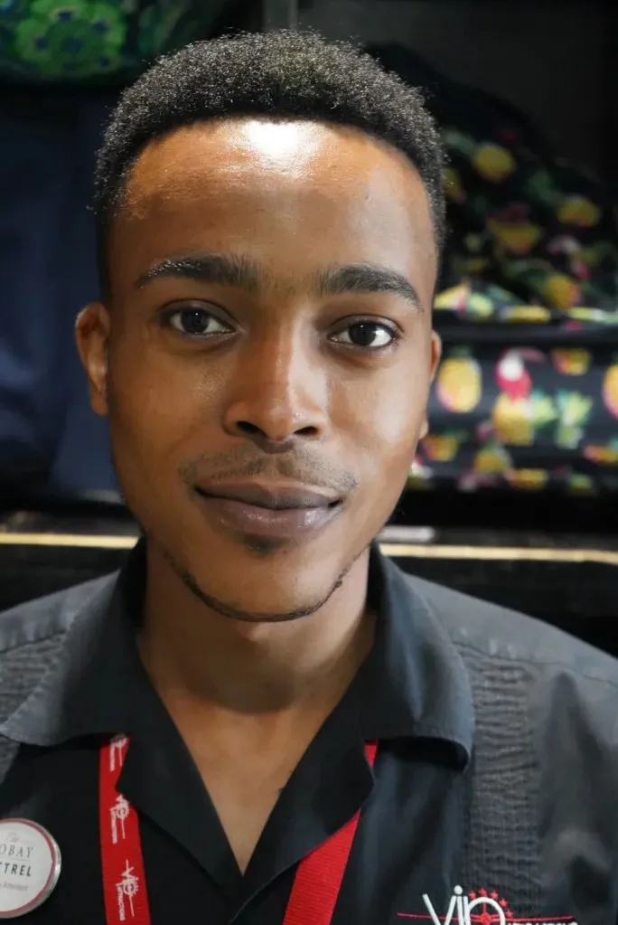 a man with a black shirt and red tie