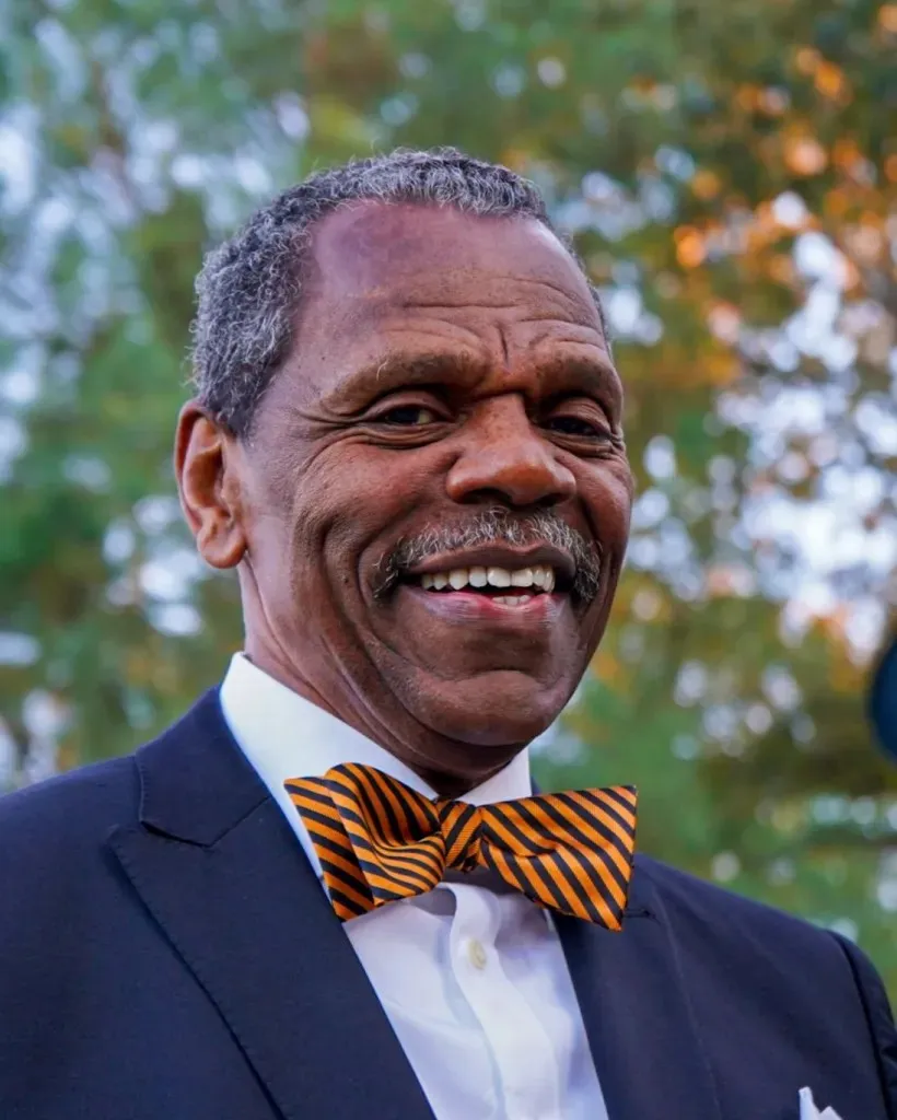 a man wearing a bow tie and a suit