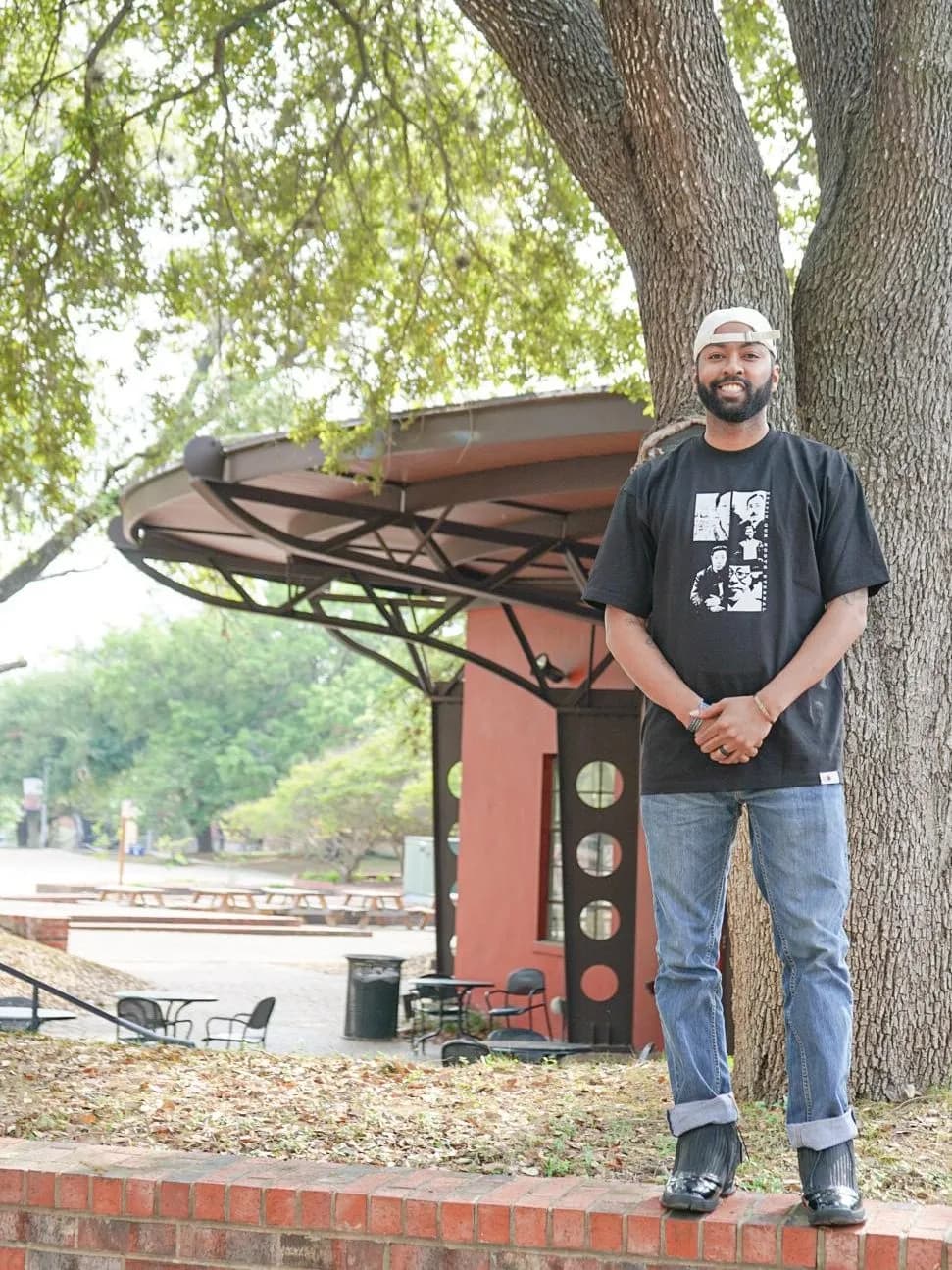 a man standing next to a tree