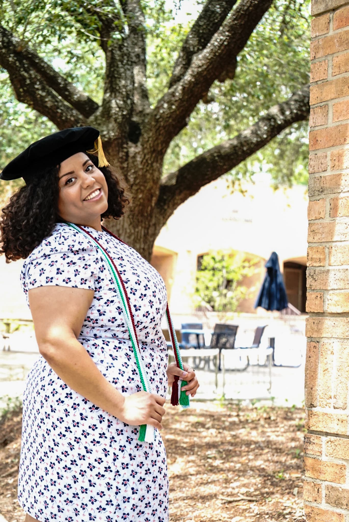 a woman in a graduation cap and dress