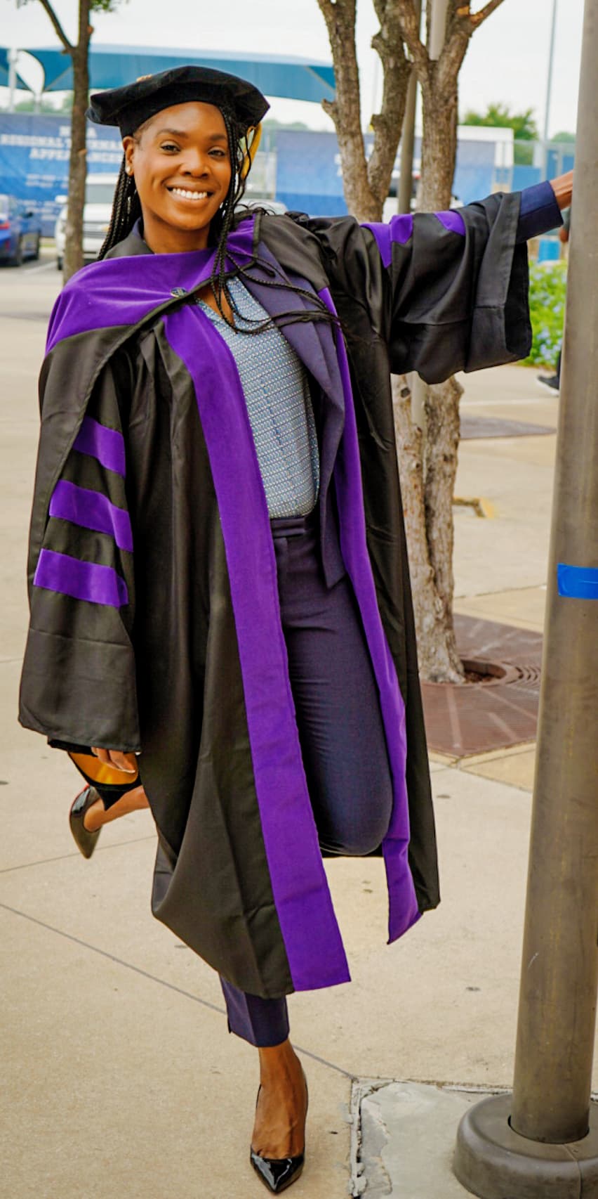 a woman in a graduation gown and cap