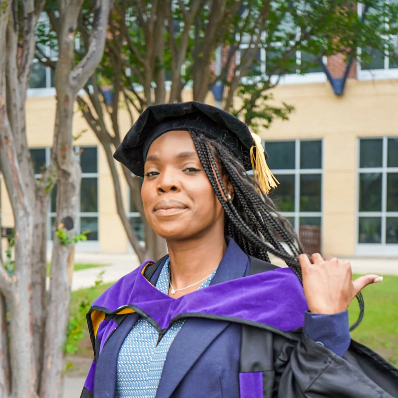 a woman in a graduation gown and cap
